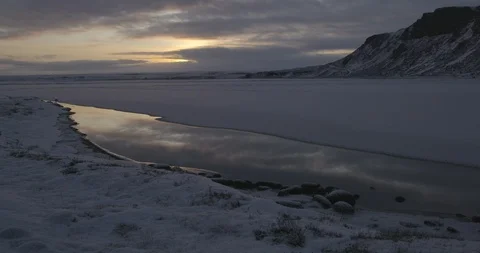 Frozen lake surface and mountain at sunset Stock-Footage 103809729