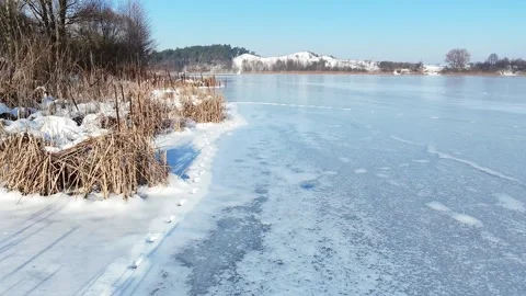 Frozen Lake Surface with Natural Ice Patterns in Winter Stock Footage 332063382