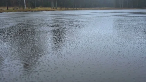 Frozen lake with a thin ice in the winter while it's raining Stock Footage 83241544