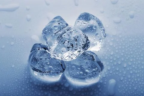 Frozen large ice cubes in the droplets of water Stock Photos