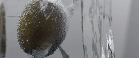 A frozen lemon rotates in an ice cube on white background Stock Footage 106006658