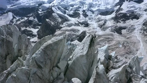 A frozen lumps of ice on the glacier surface under the snowy mountain peak. A Stock Footage 169745757