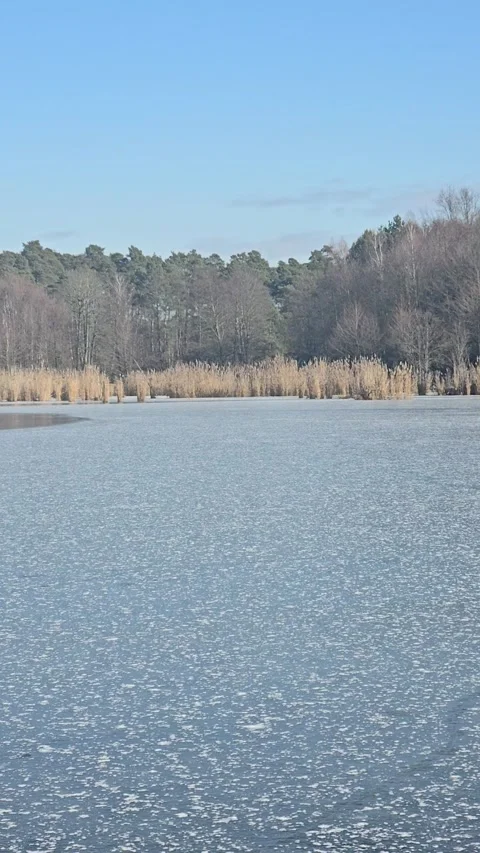 Frozen Majesty Hypnotic Ice Patterns on Winter Lake in 4K UHD Stock Footage 311392987