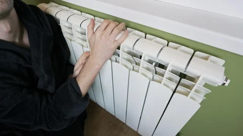 Frozen Man Checking Central Heating Radiator Temperature At Home 스톡 동영상 330296780