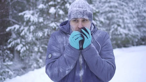 Frozen man in cold winter using telephone Stock Footage 101064370