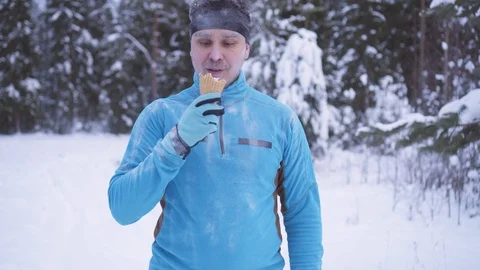 Frozen man in the snow, there is ice cream in winter, strong immunity Stock Footage 101344654