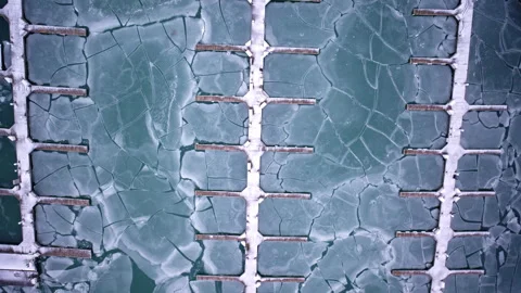Frozen marina and harbor ice formations on Lake Michigan captured in cinematic Stock Footage 331678889