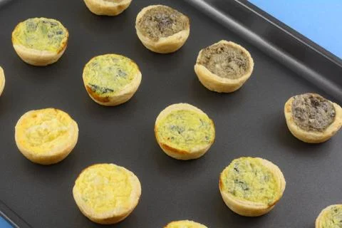 Frozen mini bite-size spinach florentine, cheese and mushroom quiches Stock Photos