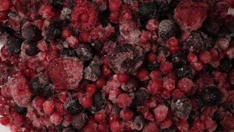 Frozen mixed berries rotating on white background Stock Footage 346738317