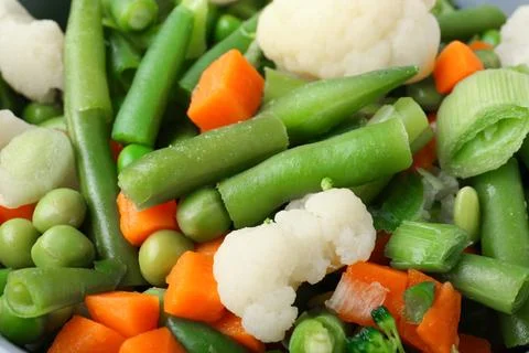 Frozen mixed vegetables as background, closeup Stock Photos