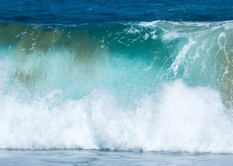 Frozen motion of large wave on beach Stock Photos