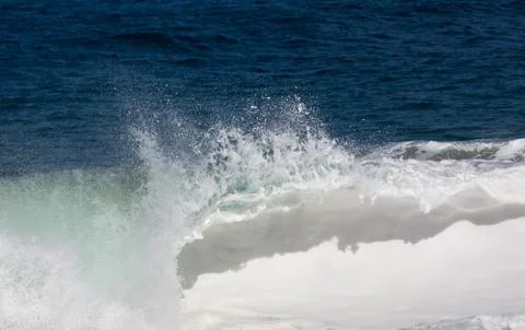 Frozen motion of large wave on beach Stock Photos