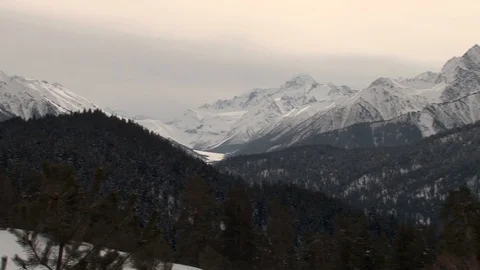 Frozen mountain lake between mountains. Shining snow peaks. Stock Footage 106857324