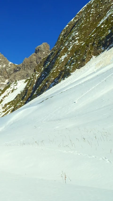 Frozen mountain path at Jochspitze with stunning views across snow-capped All Stock Footage 308295335