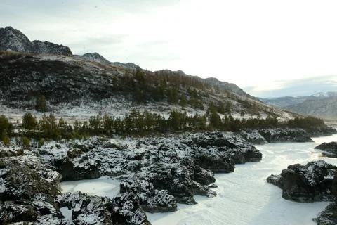 A frozen narrow bed of a beautiful river squeezed into a stone canyon passi.. Stock Photos