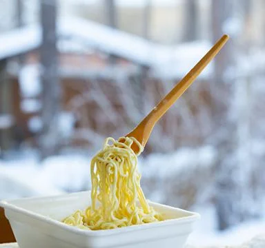 Frozen noodles on a fork on a very cold day in Siberia Stock Photos