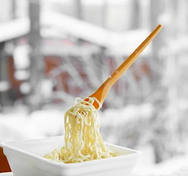 Frozen noodles on a fork on a very cold day in Siberia Stock Photos