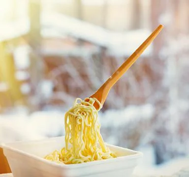 Frozen noodles on a fork on a very cold day in Siberia Stock Photos