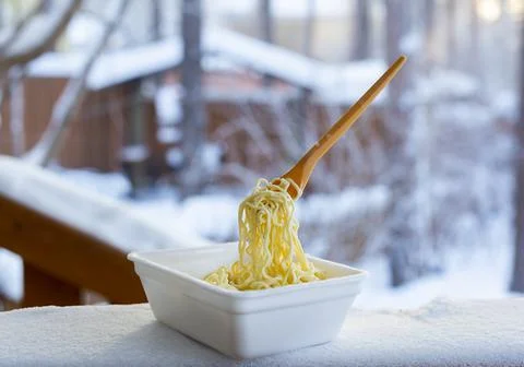 Frozen noodles on a fork on a very cold day in Siberia Stock Photos