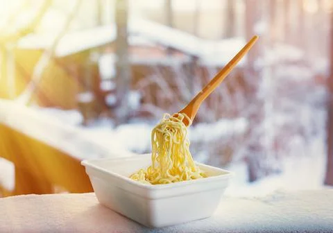 Frozen noodles on a fork on a very cold day in Siberia Stock Photos
