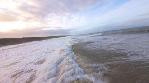 Frozen ocean meets sky at dawn, waves surge with quiet power Stock Footage 344675980