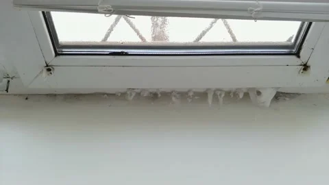 Frozen office window with ice on a window frame Video stock 153630952