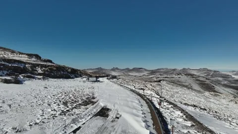 Frozen Passage: Remote Road in Snow-Covered Lesotho Highlands Stock Footage 313485713