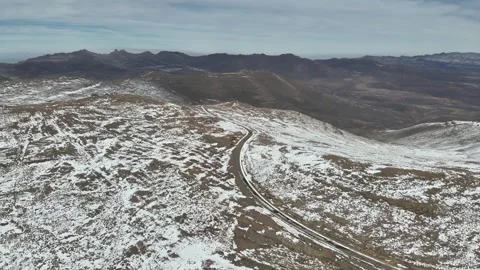 Frozen Passage: Remote Road in Snow-Covered Lesotho Highlands Stock Footage 313485775