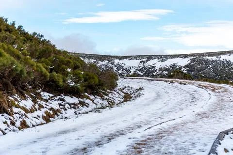 Frozen path between mountains with footprints of people and animals marked in Stock Photos