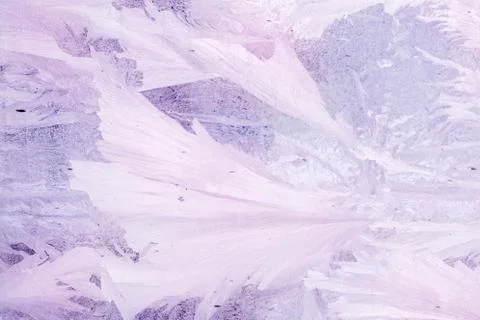 Frozen pattern on the window glass in the winter and tinted in purple Stock Photos