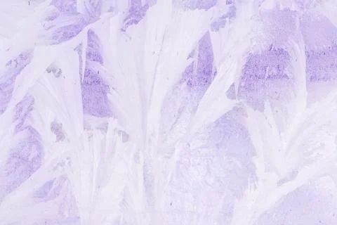 Frozen pattern on the window glass in the winter and tinted in purple Stock Photos