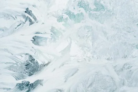 Frozen pattern on the window glass in the winter and tinted in blue Foto stock