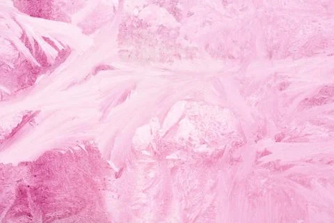 Frozen pattern on the window glass in the winter and tinted in pink Stock Photos
