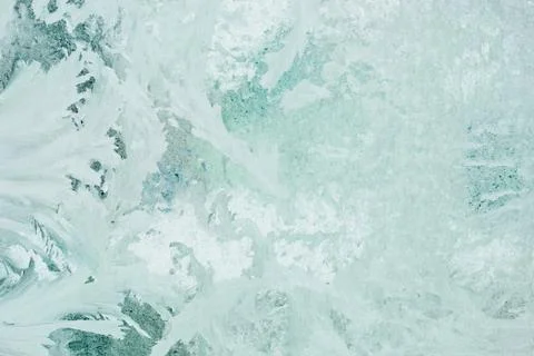 Frozen pattern on the window glass in the winter and tinted in green Stock Photos
