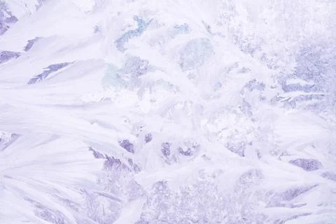 Frozen pattern on the window glass in the winter and tinted in purple Stock Photos