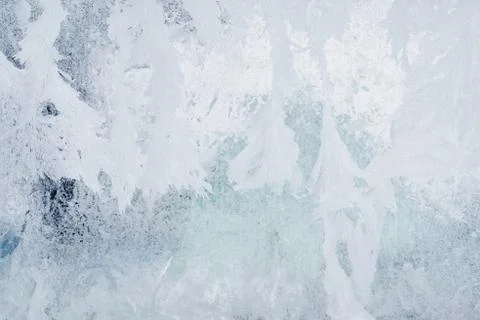 Frozen pattern on the window glass in the winter and tinted in blue Foto stock