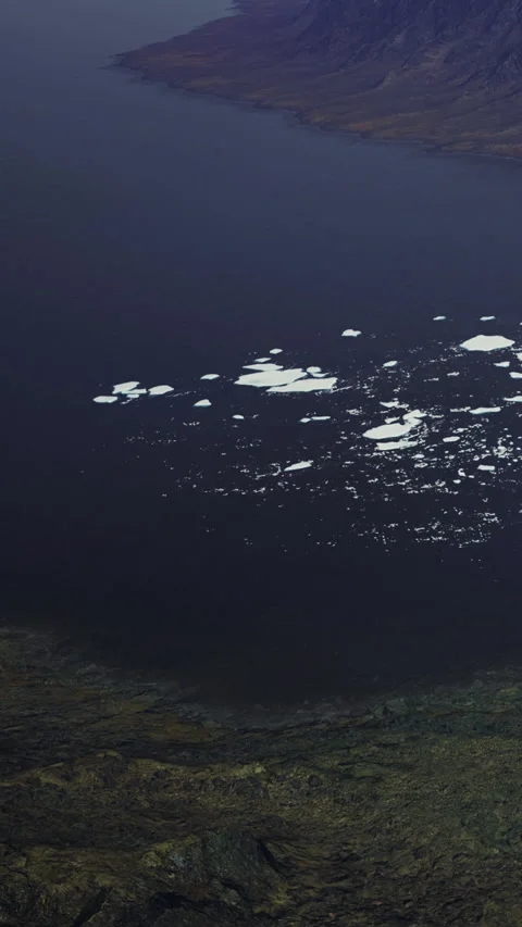 Frozen patterns dance on the dark waters of a secluded Arctic bay Stock Footage 334253193