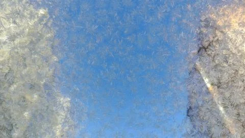 Frozen patterns on glass in winter Stock Photos