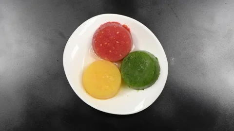 Frozen peach raspberry and kiwi smoothie on a white plate. Stock Footage 184069204