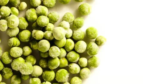 Frozen Peas on white surface Stock Photos