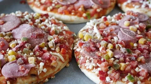 Frozen pizza in a baking tray, ready pizza, frozen foods, Stock Footage 166749137