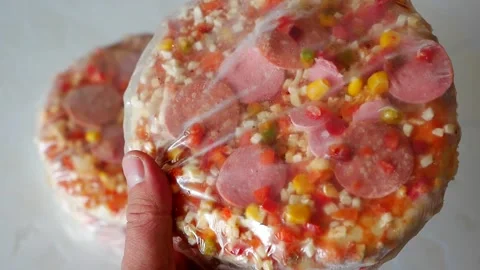Frozen pizza in a baking tray, ready pizza, frozen foods, Stock Footage 166749197
