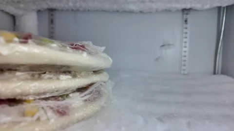 Frozen pizza stacked in a freezer Stock Footage 340376661