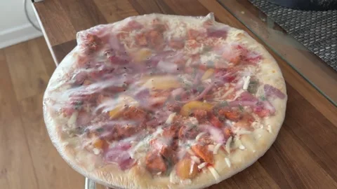 Frozen Pizza Wrapped in Plastic Representing Unhealthy Processed Convenience Stock Footage 337506560