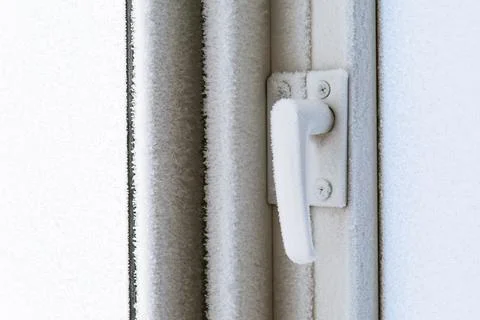 Frozen plastic window hardware lock. Stock Photos