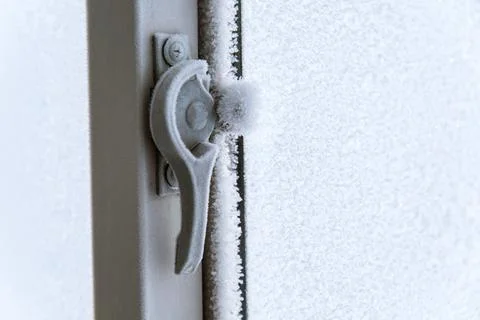 Frozen plastic window hardware lock. Stock Photos