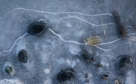 Frozen puddle and rocks Stock Photos