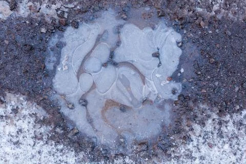 Frozen puddle close-up texture Stock Photos