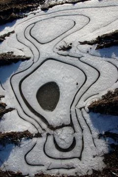 Frozen puddle with spacious circular air cavities Stock-Fotos