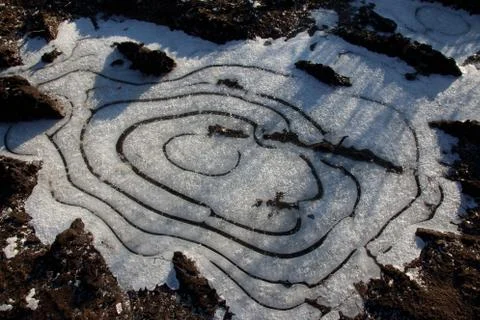 Frozen puddle with spacious circular air cavities Stock Photos